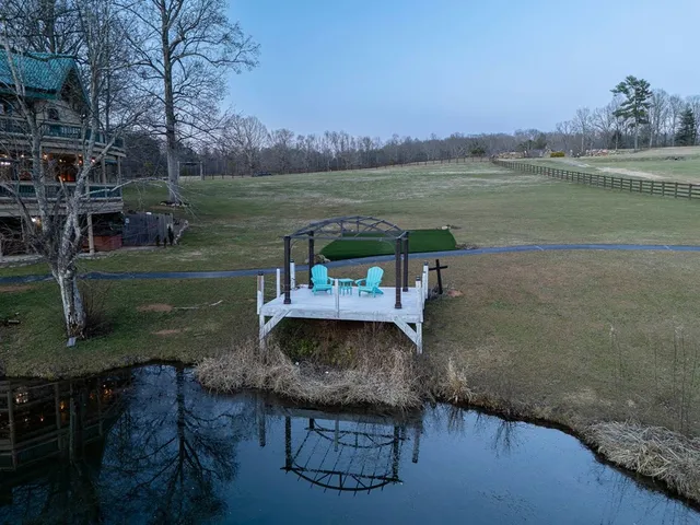 a view of a house with a yard and sitting area