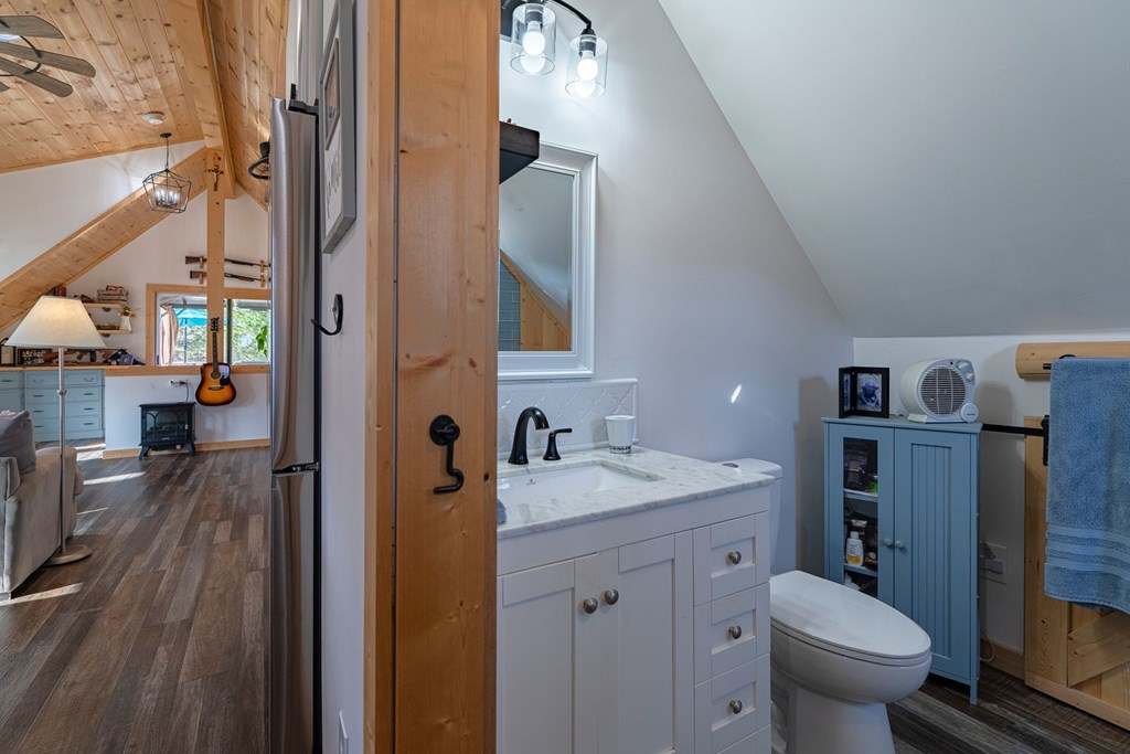 201 Mountainside Parkway Ellijay, GA 30536 - Photo 44 of 78 a bathroom with a toilet sink and mirror