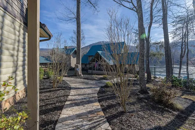 a front view of a house with a garden