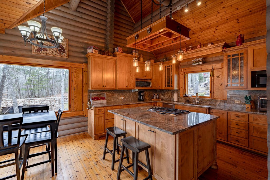 201 Mountainside Parkway Ellijay, GA 30536 - Photo 5 of 78 a kitchen with stainless steel appliances granite countertop a stove a sink dishwasher and cabinets with wooden floor