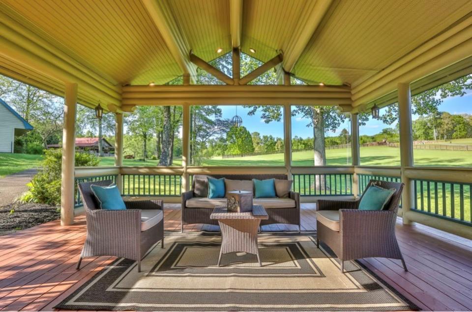 201 Mountainside Parkway Ellijay, GA 30536 - Photo 72 of 78 a view of a patio with couches chairs dining table and chairs