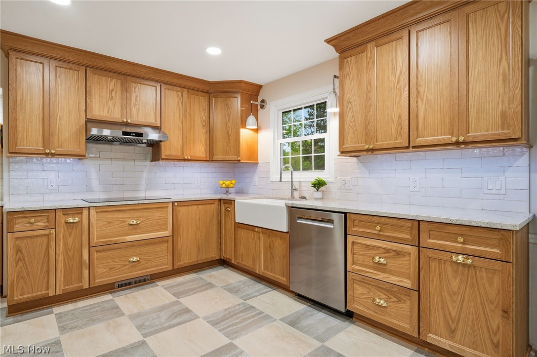1515 Barlow Road Hudson, OH 44236 - Photo 8 of 31 Completely renovated kitchen with custom cabinetry, induction cooktop, stainless steel appliances, and porcelain tile flooring!