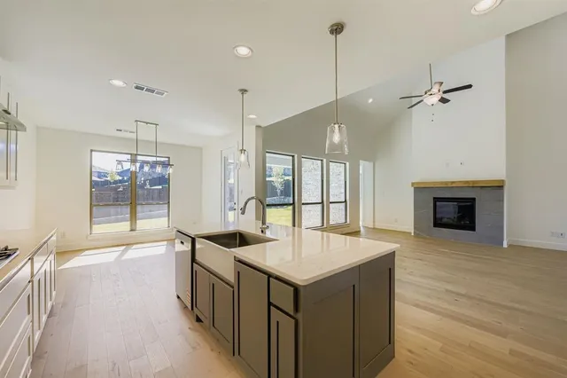 a kitchen with a stove a sink and a refrigerator