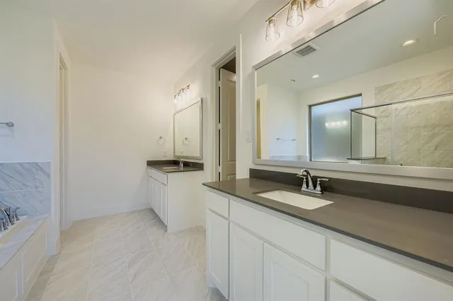 a bathroom with a bathtub and a shower