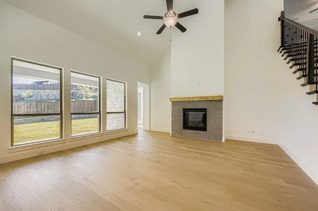 a view of an empty room with a fireplace and a window
