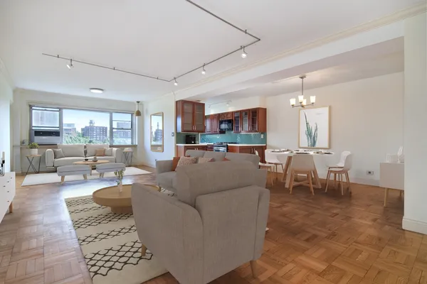a living room with furniture and a dining table with kitchen view