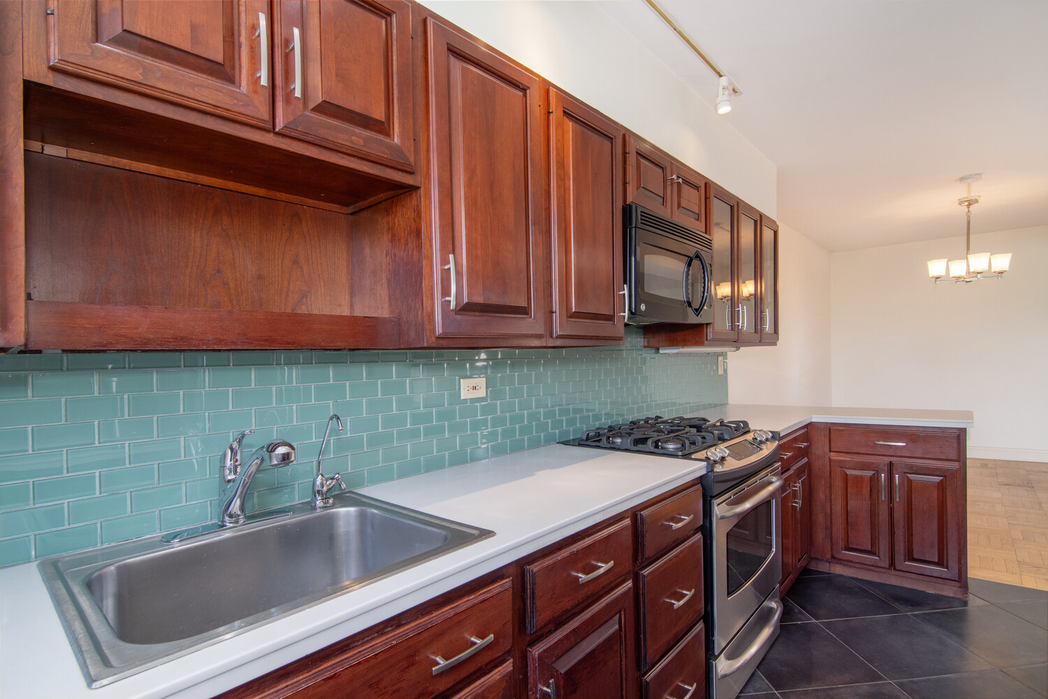 750 Kappock Street, Unit 807 Bronx, NY 10463 - Photo 11 of 28 a kitchen with stainless steel appliances granite countertop a sink and cabinets