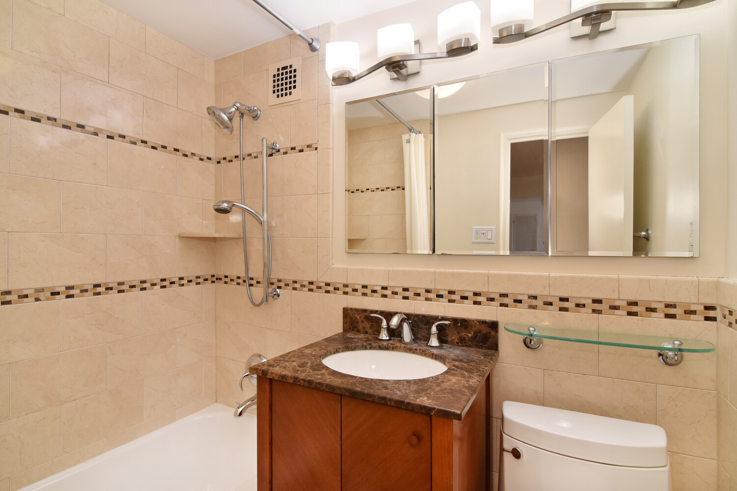 750 Kappock Street, Unit 807 Bronx, NY 10463 - Photo 18 of 28 a bathroom with a granite countertop sink a mirror a toilet and shower