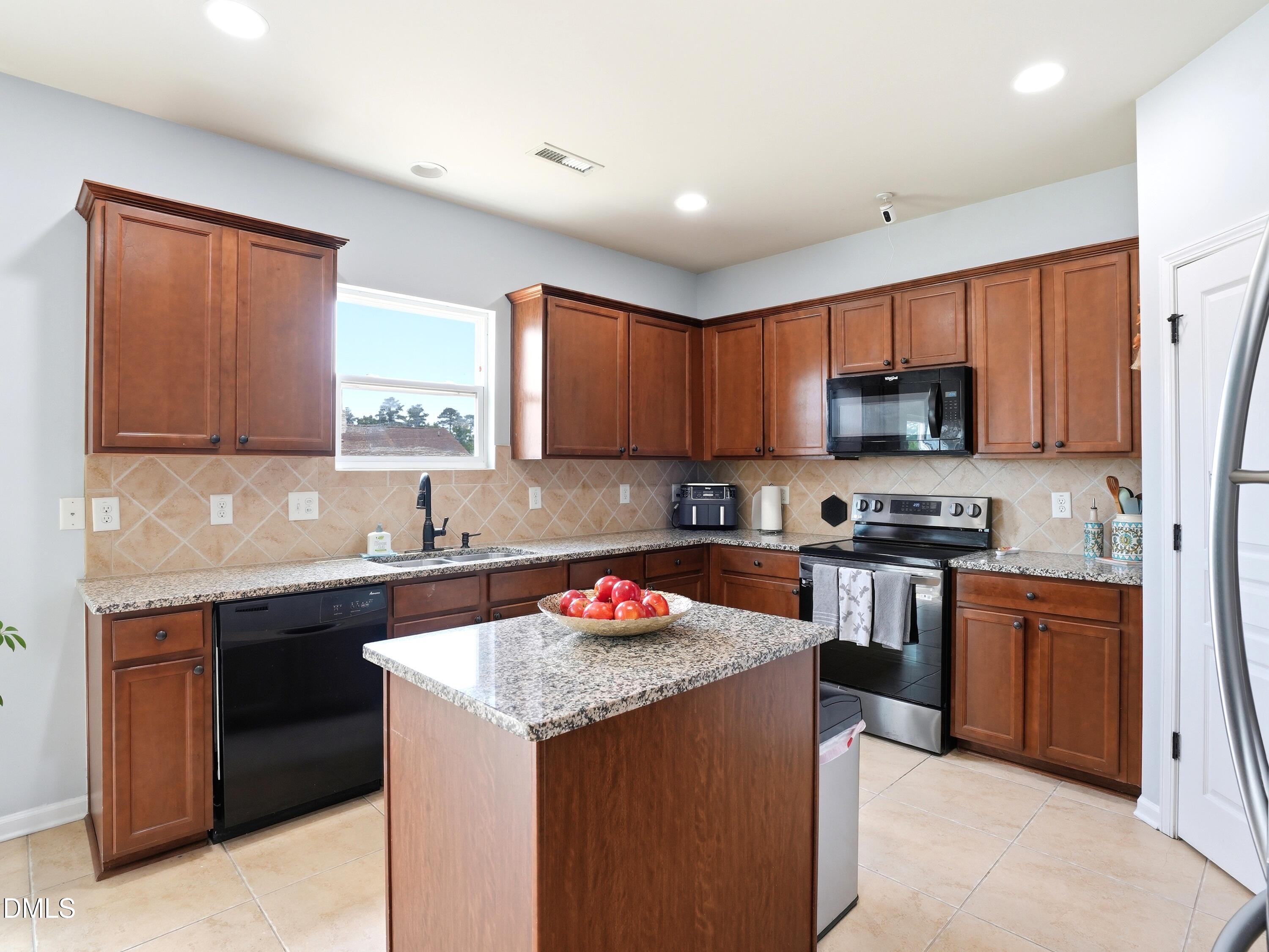 8128 Hovingham Way Raleigh, NC 27616 - Photo 11 of 40 a kitchen with a sink stove top oven and microwave