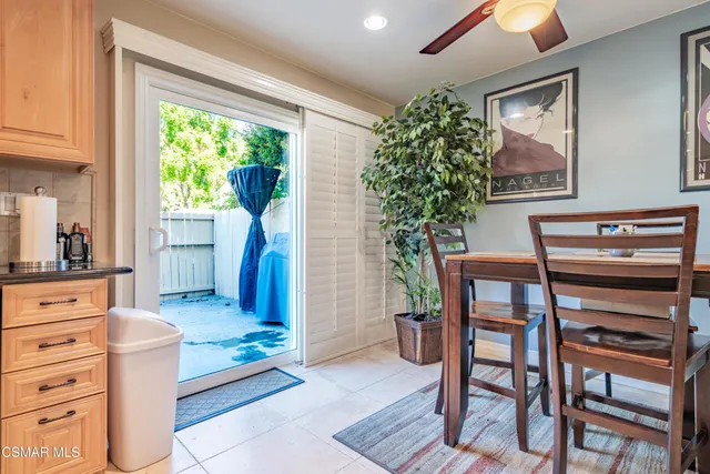 a living room with furniture a desk and chair with windows