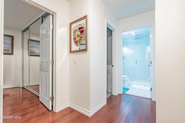 a view of a hallway with wooden floor