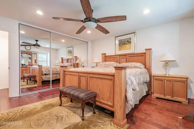 a bed room with a bed and a chair