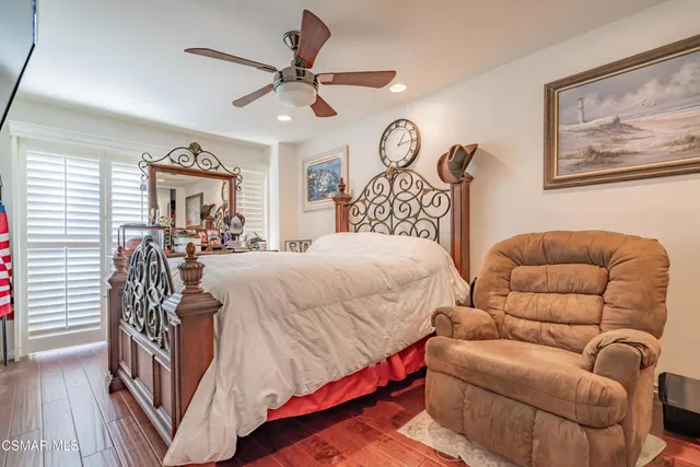 a bedroom with a bed couch and window