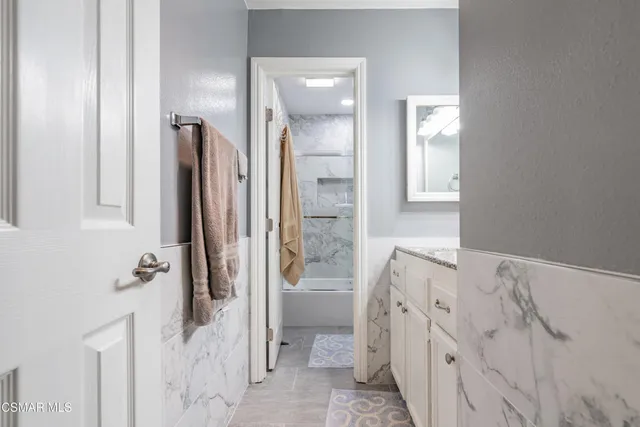 a bathroom with a tub sink and toilet