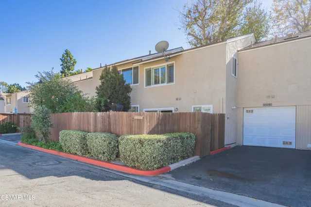 a view of a back yard with potted plants