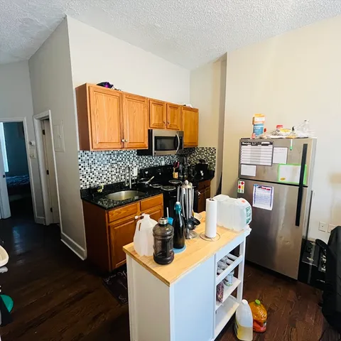 a kitchen with a sink appliances and cabinets