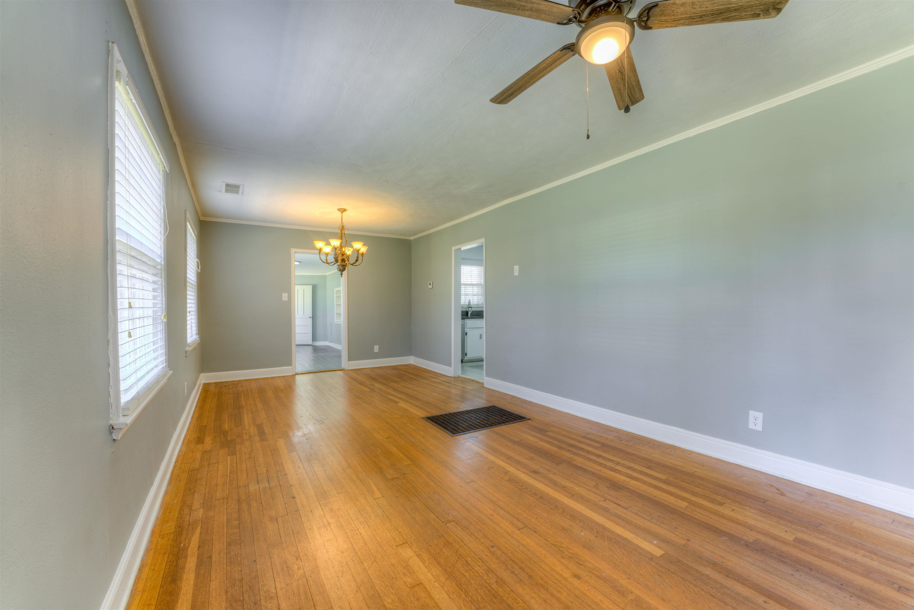 1180 Vaughn Road Memphis, TN 38122 - Photo 3 of 26 a view of empty room with wooden floor and fan