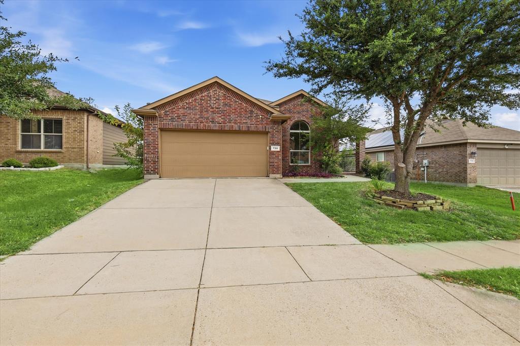 720 Rio Bravo Drive Fort Worth, TX 76052 - Photo 2 of 38 Brick exterior home featuring an arched window, attached garage, and concrete driveway