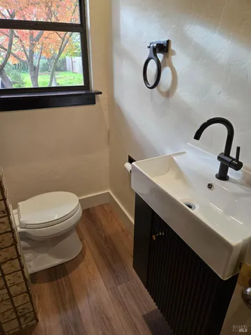 a bathroom with a toilet a sink and mirror