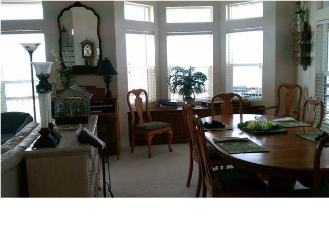 256 North Wall Street Inlet Beach, FL 32461 - Photo 3 of 32 a living room with furniture a chandelier and a large window
