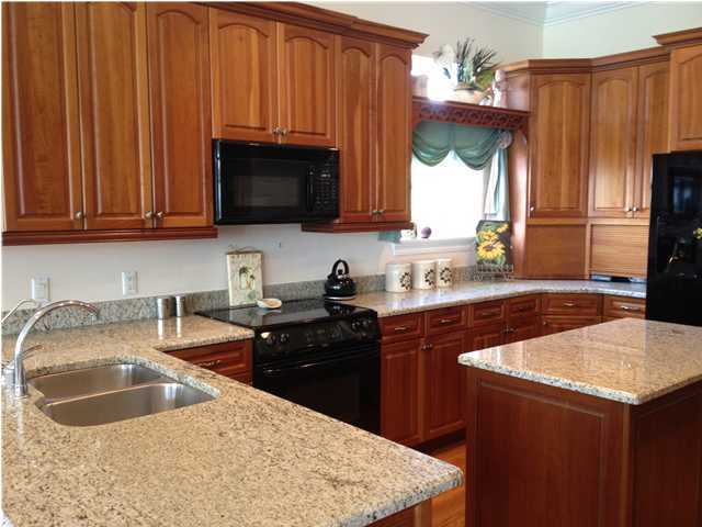 256 North Wall Street Inlet Beach, FL 32461 - Photo 4 of 32 a kitchen with granite countertop a sink a stove and a microwave