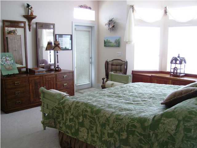 256 North Wall Street Inlet Beach, FL 32461 - Photo 8 of 32 a bedroom with a bed and dresser with mirror