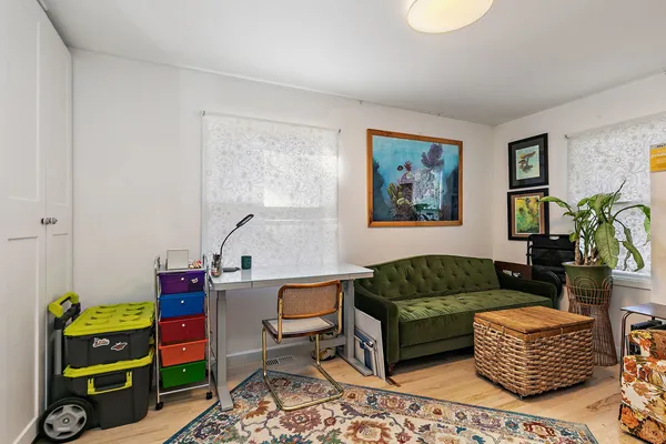 a view of a brick house with a chairs in patio