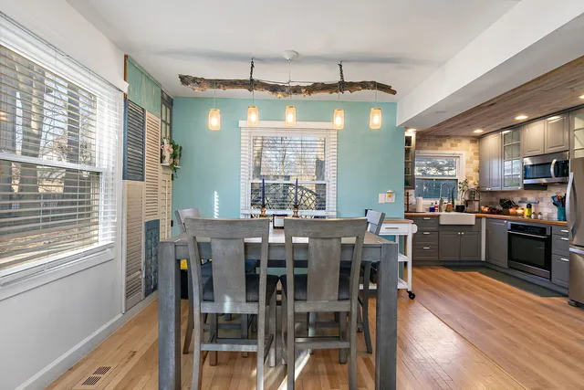 a kitchen with stainless steel appliances a sink cabinets and wooden floor