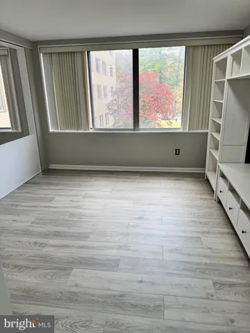 a view of room with window and wooden floor
