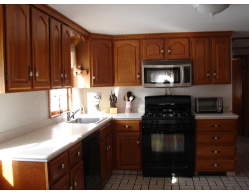 49 Ramshorn Road Dudley, MA 01571 - Photo 5 of 19 a kitchen with a sink a stove and cabinets
