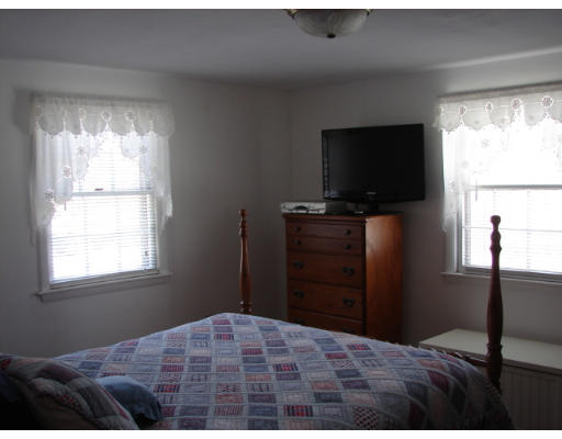 49 Ramshorn Road Dudley, MA 01571 - Photo 9 of 19 a bedroom with a bed and a flat screen tv