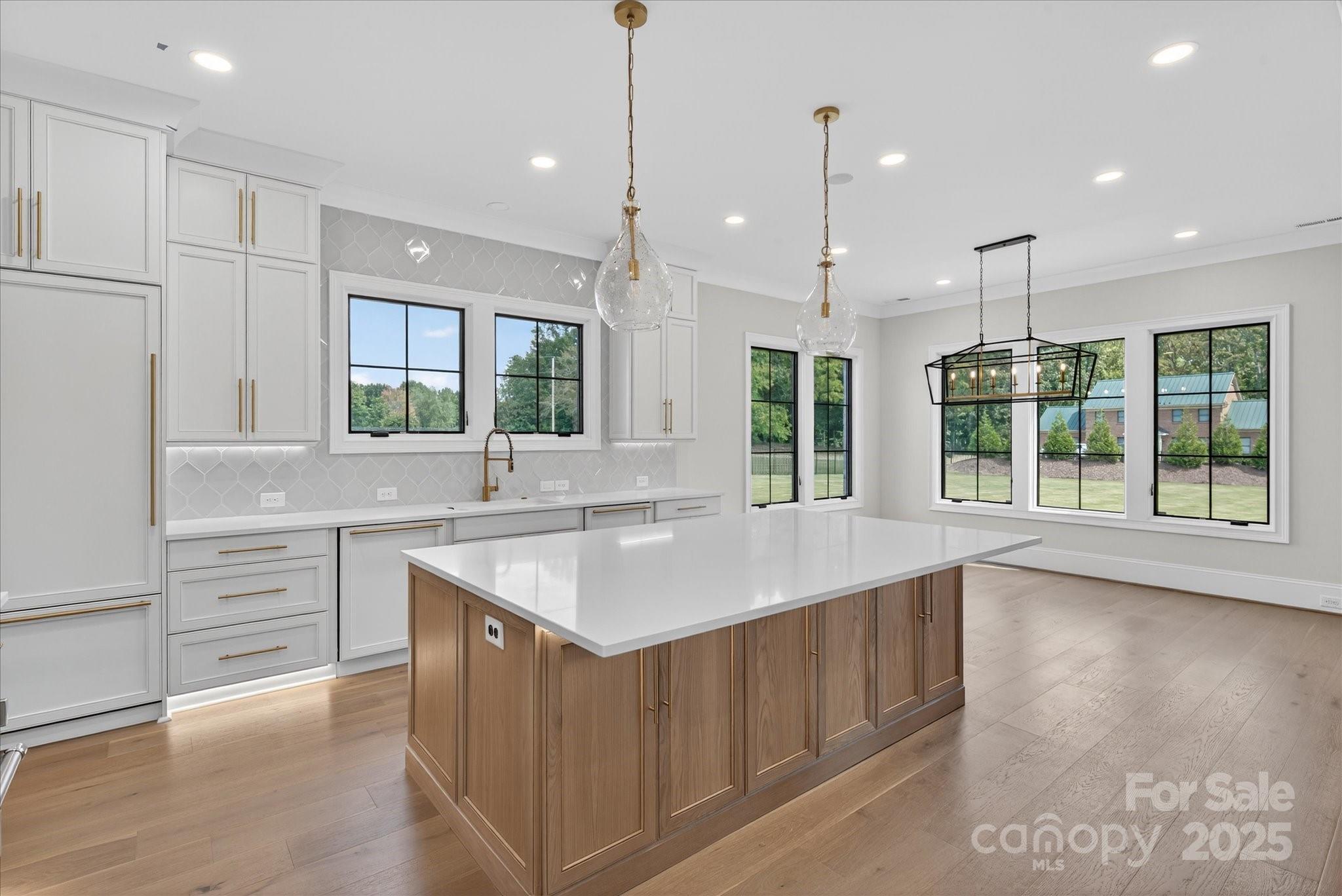 1405 Waxhaw-Marvin Road Waxhaw, NC 28173 - Photo 11 of 46 a kitchen with counter top space sink stainless steel appliances and windows