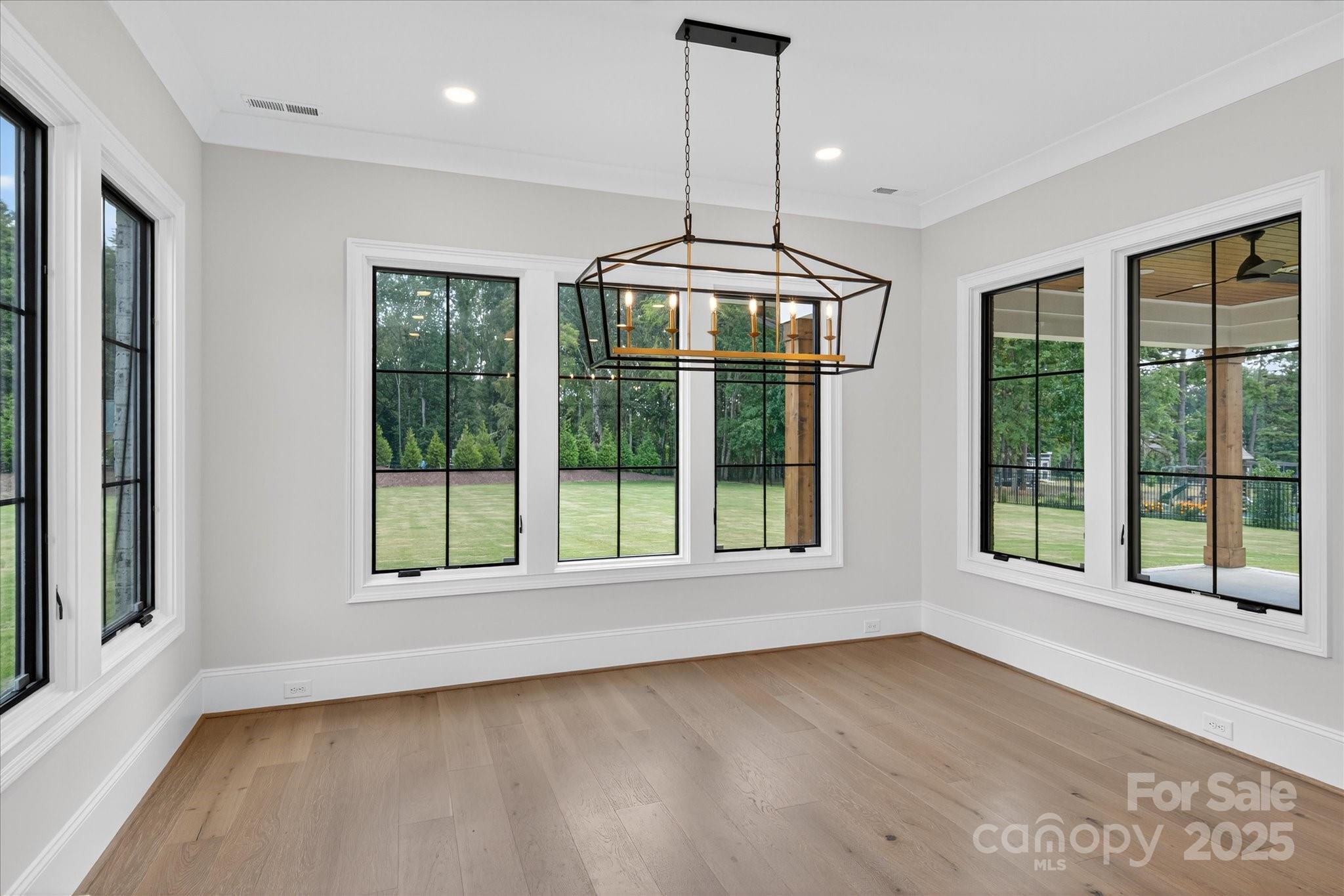 1405 Waxhaw-Marvin Road Waxhaw, NC 28173 - Photo 14 of 46 a view of an empty room with wooden floor and a window
