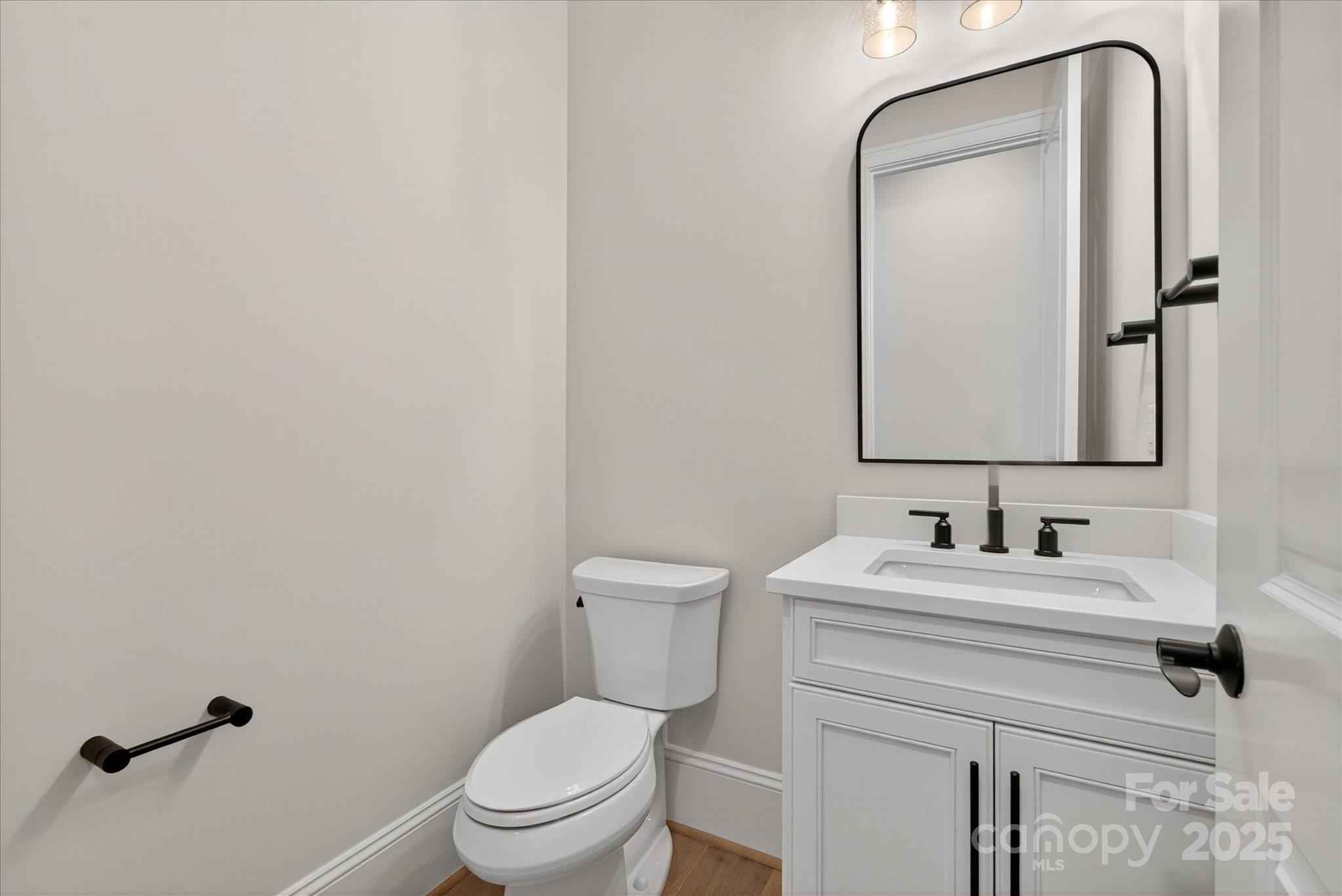 1405 Waxhaw-Marvin Road Waxhaw, NC 28173 - Photo 17 of 46 a bathroom with a toilet sink and mirror