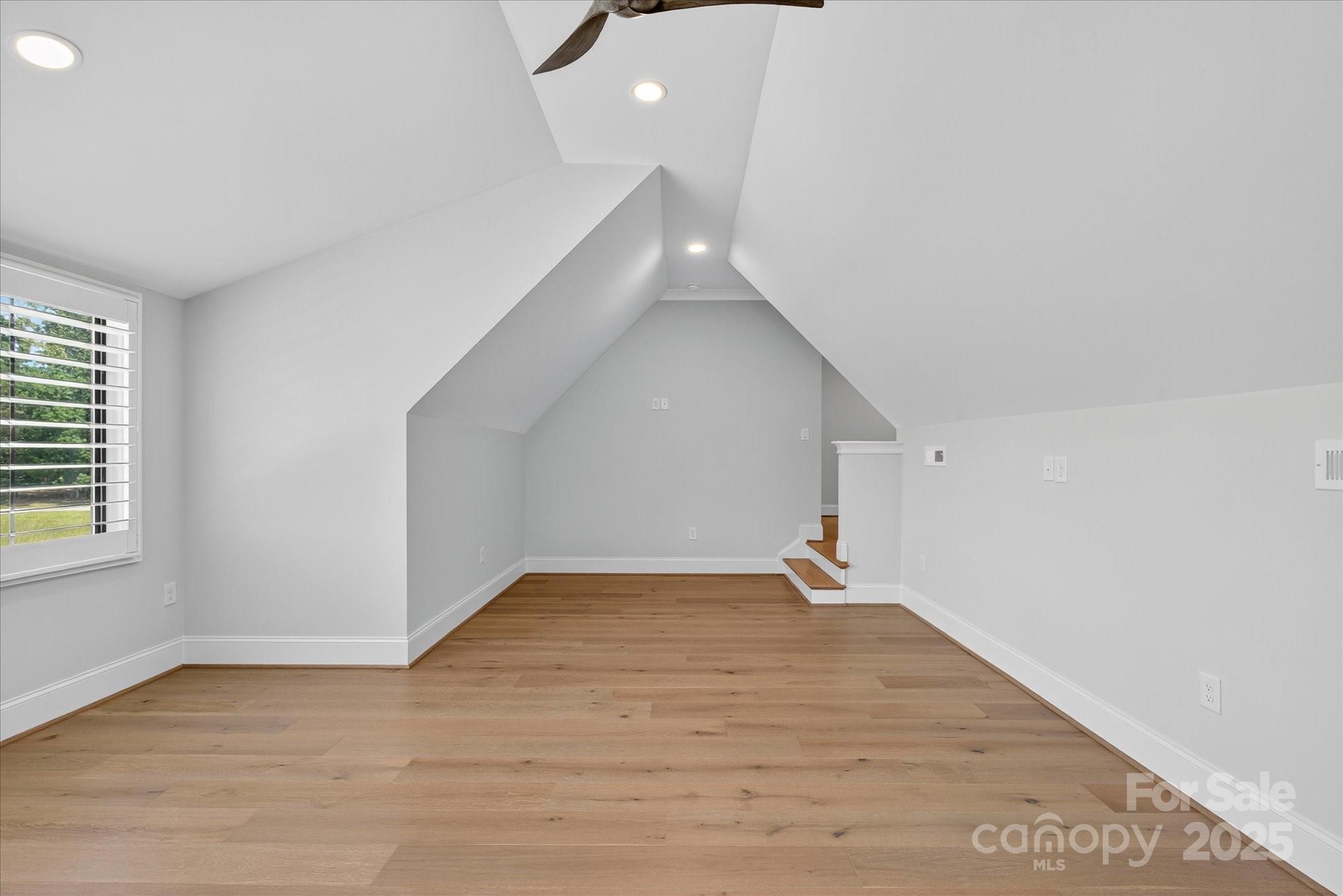 1405 Waxhaw-Marvin Road Waxhaw, NC 28173 - Photo 29 of 46 a view of an empty room with wooden floor and a window
