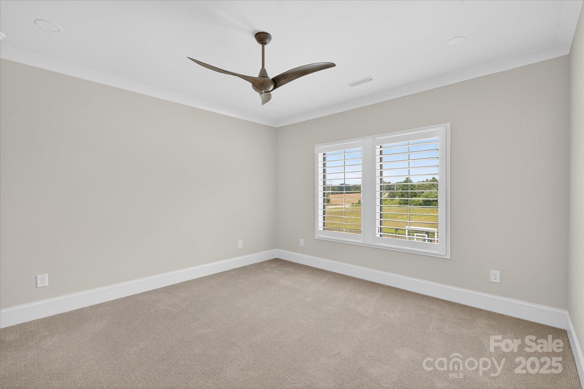 1405 Waxhaw-Marvin Road Waxhaw, NC 28173 - Photo 30 of 46 an empty room with a window and a ceiling fan