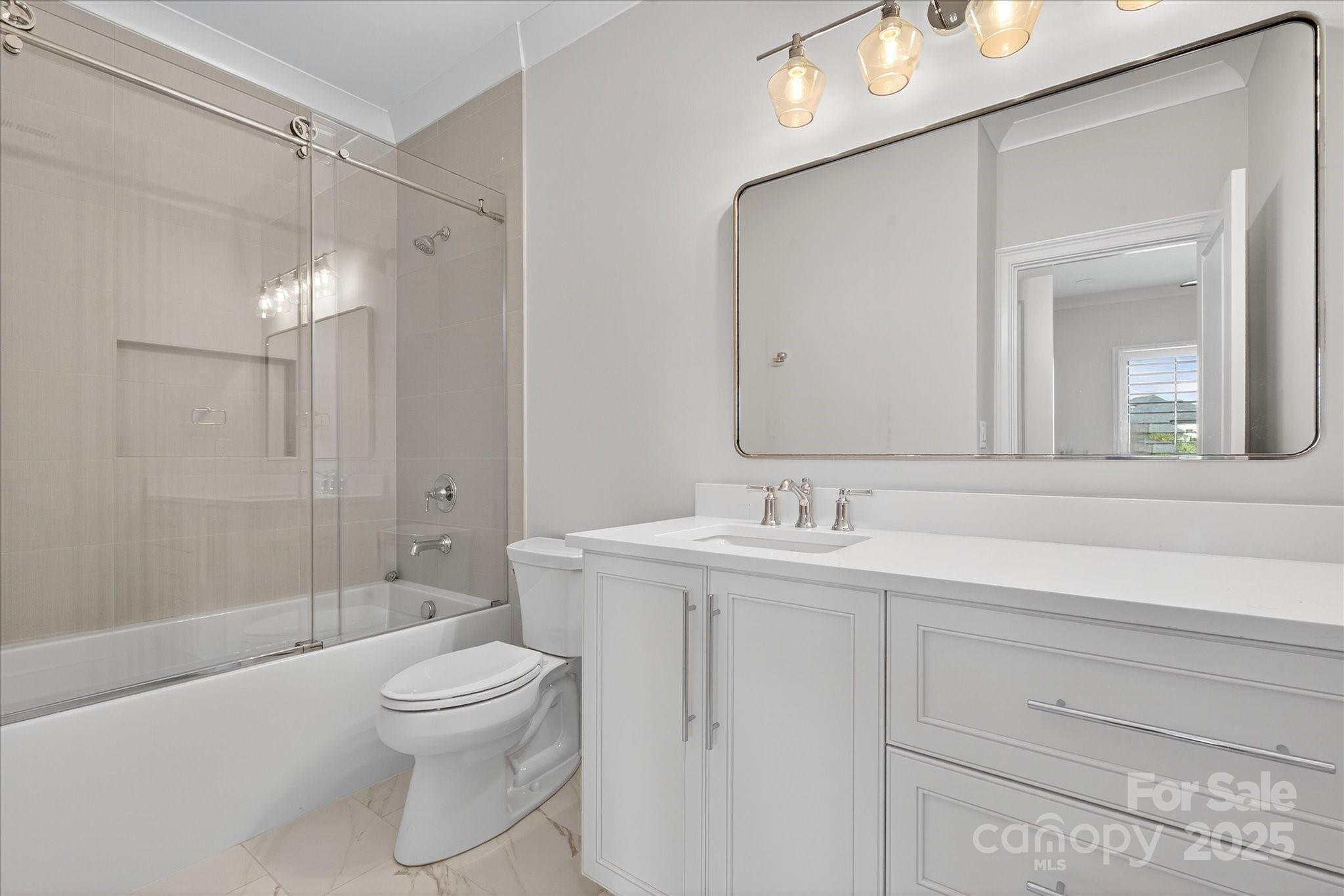 1405 Waxhaw-Marvin Road Waxhaw, NC 28173 - Photo 32 of 46 a bathroom with a toilet a sink a glass door a shower and a mirror