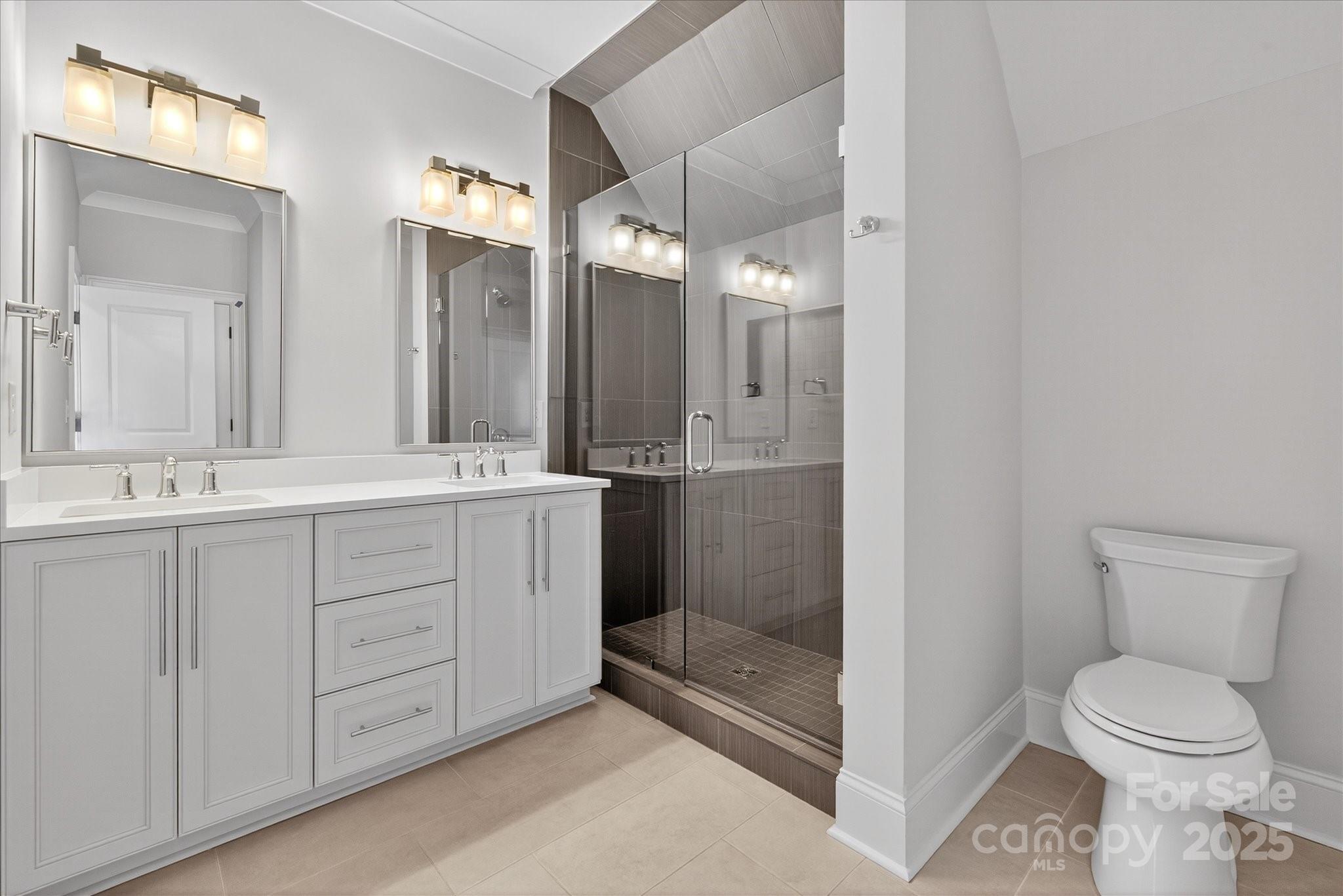 1405 Waxhaw-Marvin Road Waxhaw, NC 28173 - Photo 36 of 46 a bathroom with a double vanity sink toilet and shower