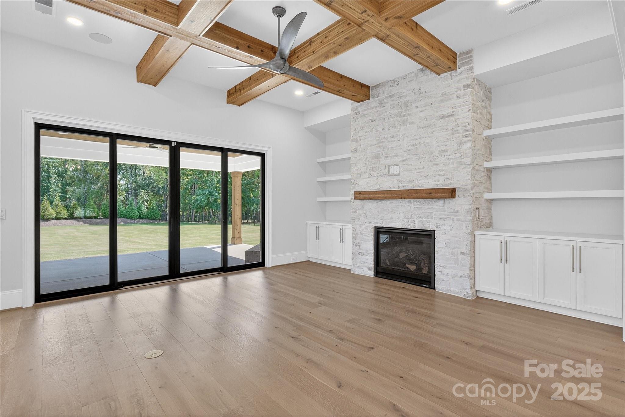 1405 Waxhaw-Marvin Road Waxhaw, NC 28173 - Photo 7 of 46 a view of an empty room with wooden floor fireplace and a window