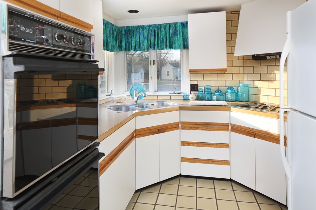 39 Beach Street Wareham, MA 02571 - Photo 11 of 24 a kitchen with kitchen island granite countertop a stove and a refrigerator