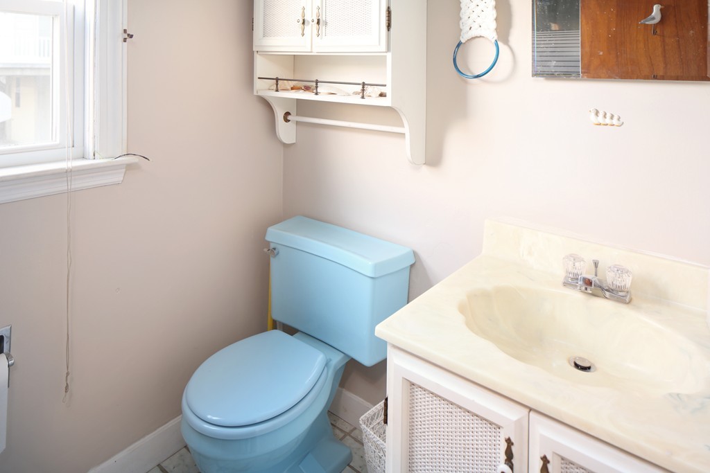 39 Beach Street Wareham, MA 02571 - Photo 20 of 24 a white toilet sitting next to a bathroom sink