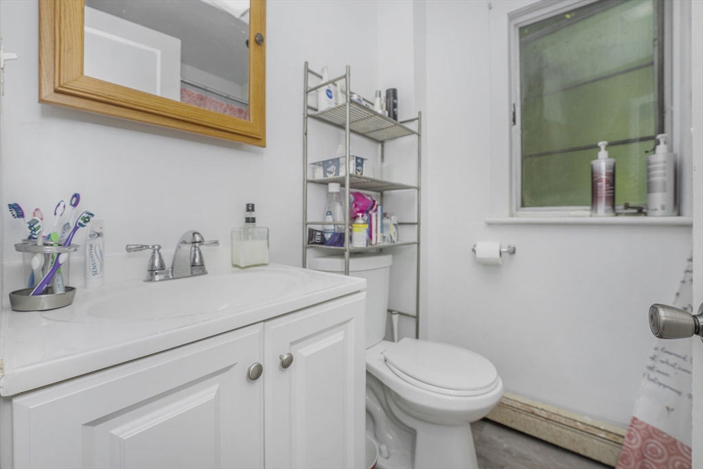 17 Dresser Street Southbridge, MA 01550 - Photo 2 of 3 a bathroom with a sink a toilet and mirror