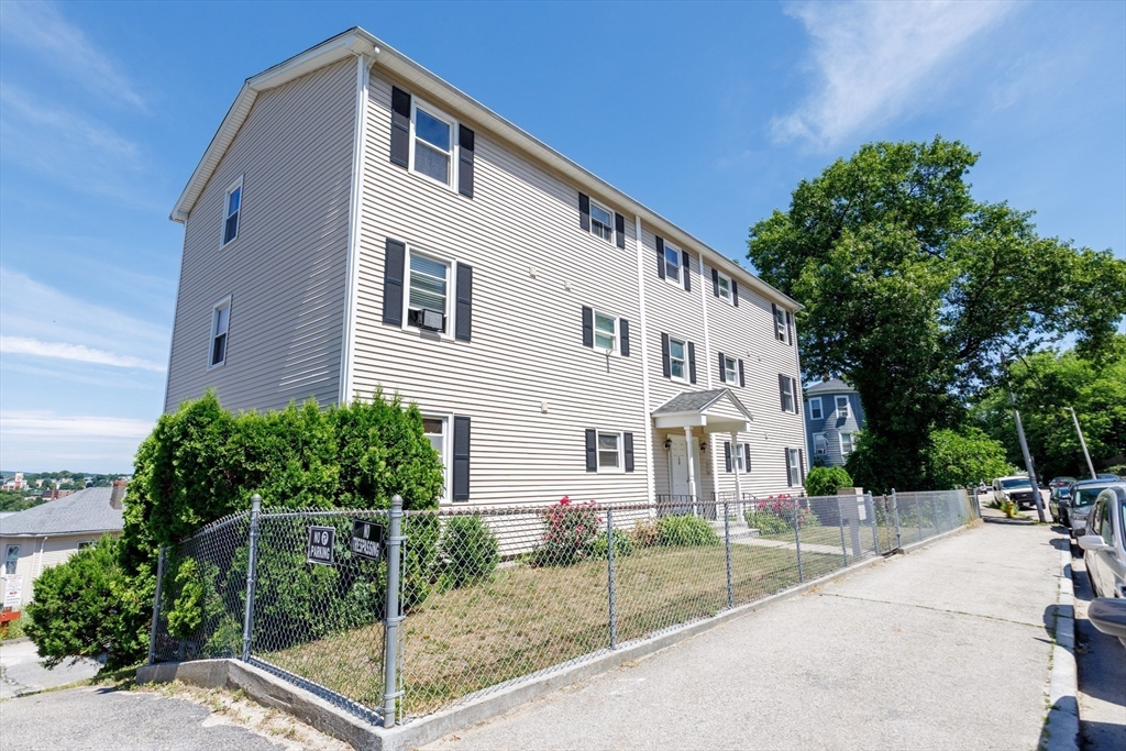 170 Perry Avenue, Unit 3A Worcester, MA 01610 - Photo 1 of 16 a front view of a house with a yard