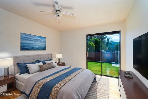 a bedroom with bed and flat tv screen