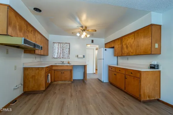 a large kitchen with stainless steel appliances granite countertop a stove a sink dishwasher and a refrigerator