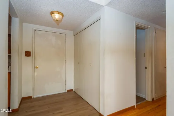 a view of an empty room with wooden floor