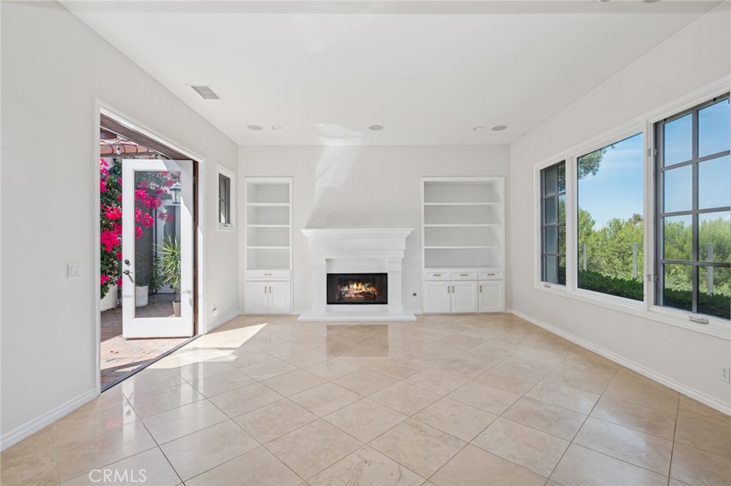 4 Still Water Newport Coast, CA 92657 - Photo 12 of 43 a view of an empty room with a fireplace and a window