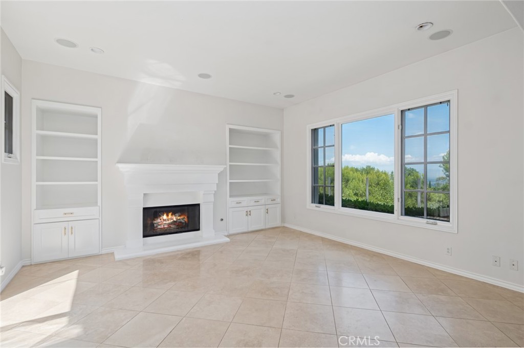 4 Still Water Newport Coast, CA 92657 - Photo 13 of 43 an empty room with furniture and a fireplace