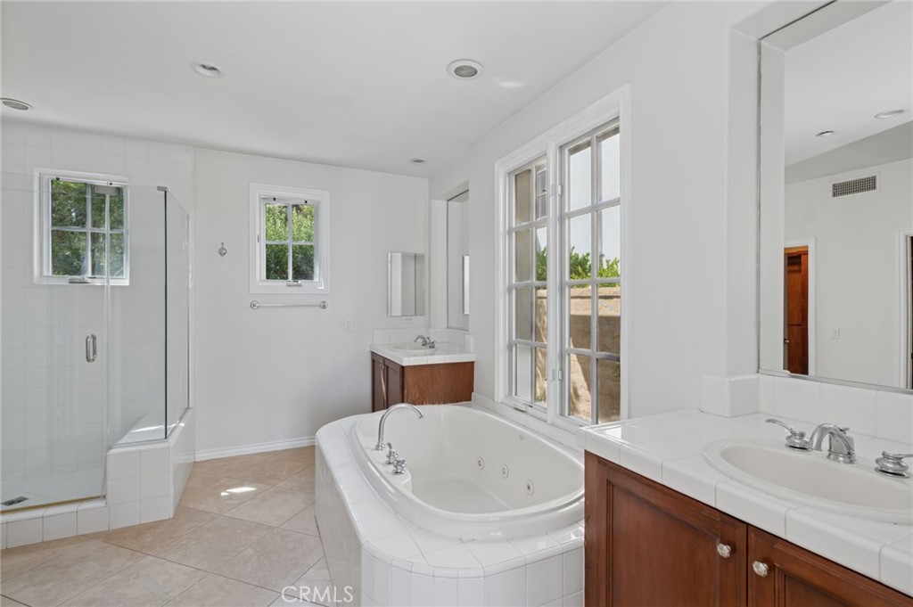 4 Still Water Newport Coast, CA 92657 - Photo 21 of 43 a bathroom with a tub sink and mirror