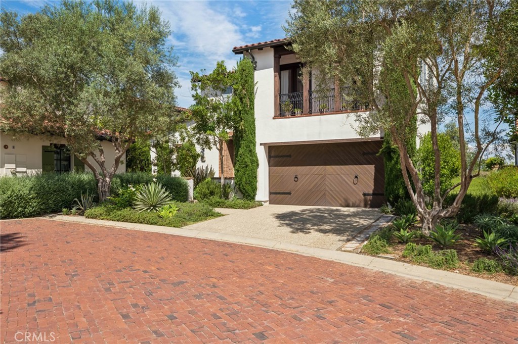 4 Still Water Newport Coast, CA 92657 - Photo 35 of 43 a front view of a house with a yard and garage